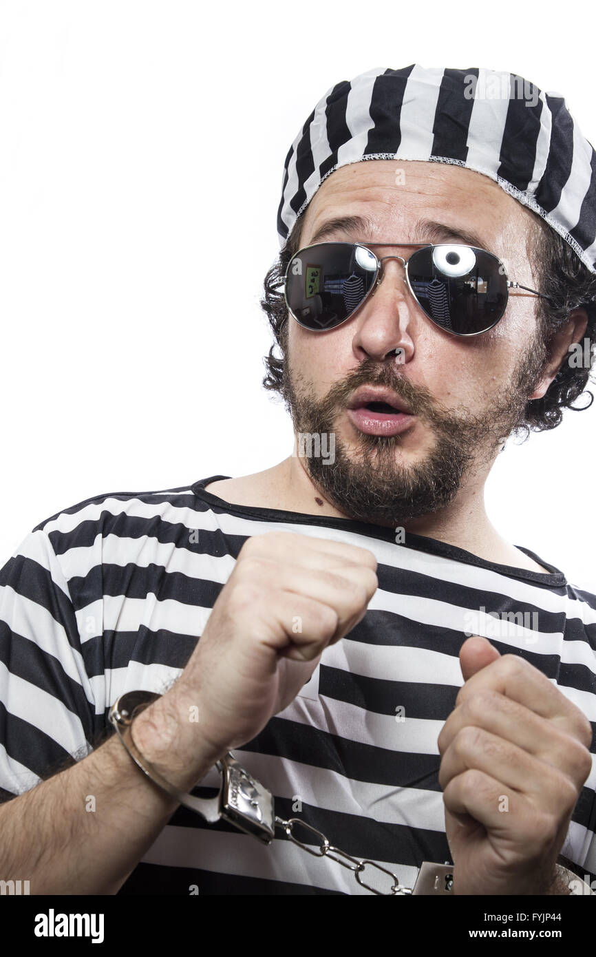 Detention camp, Desperate, portrait of a man prisoner in prison garb, over white background Stock Photo