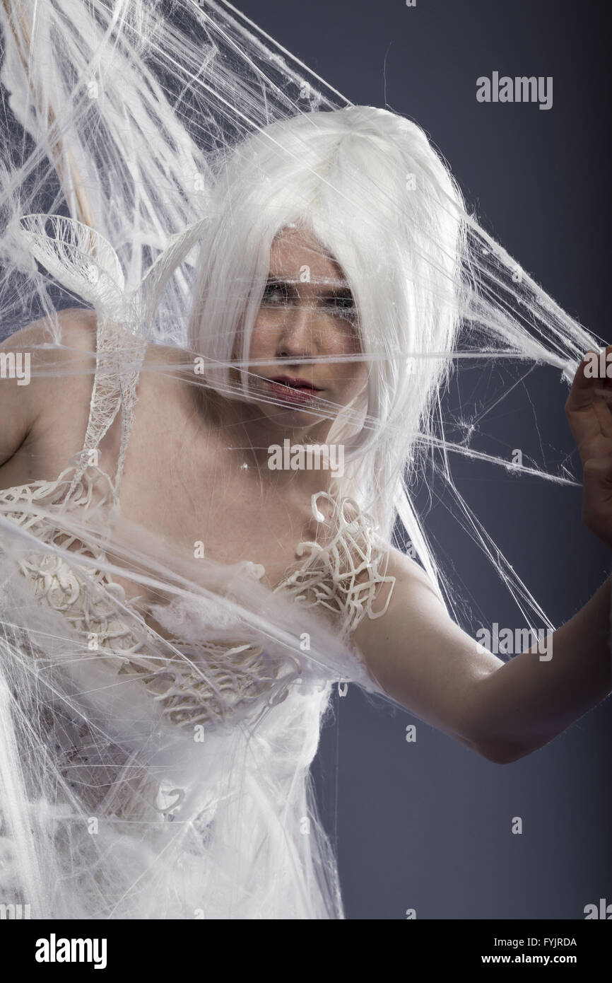beautiful young woman trapped in a spider web, communications Stock