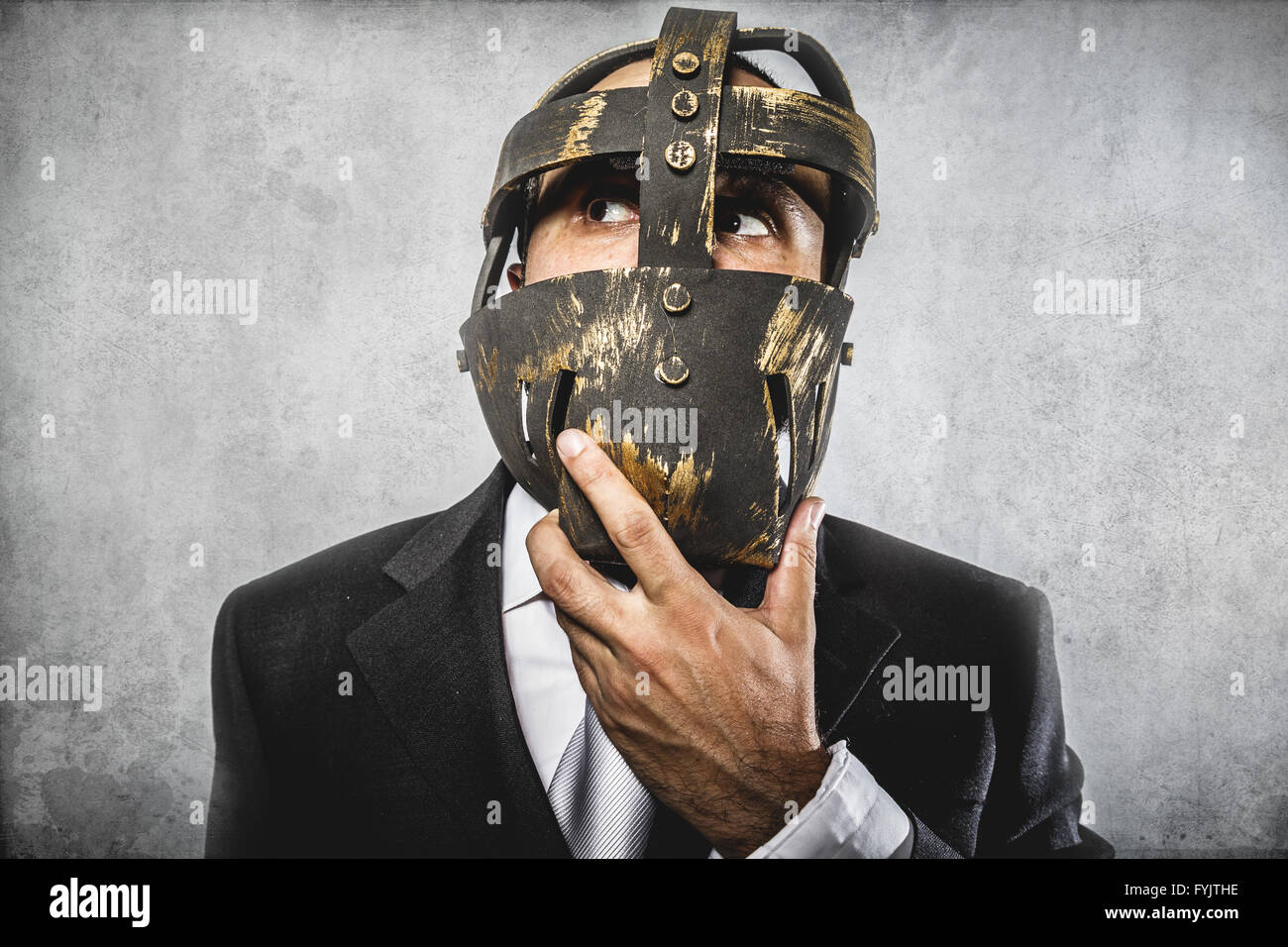 thinking, dangerous business man with iron mask and expressions Stock Photo
