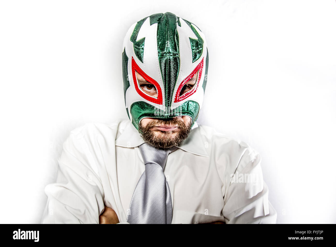 senior, aggressive businessman with Mexican warrior mask Stock Photo