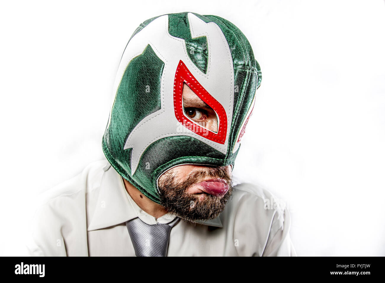 sad, aggressive businessman with Mexican warrior mask Stock Photo