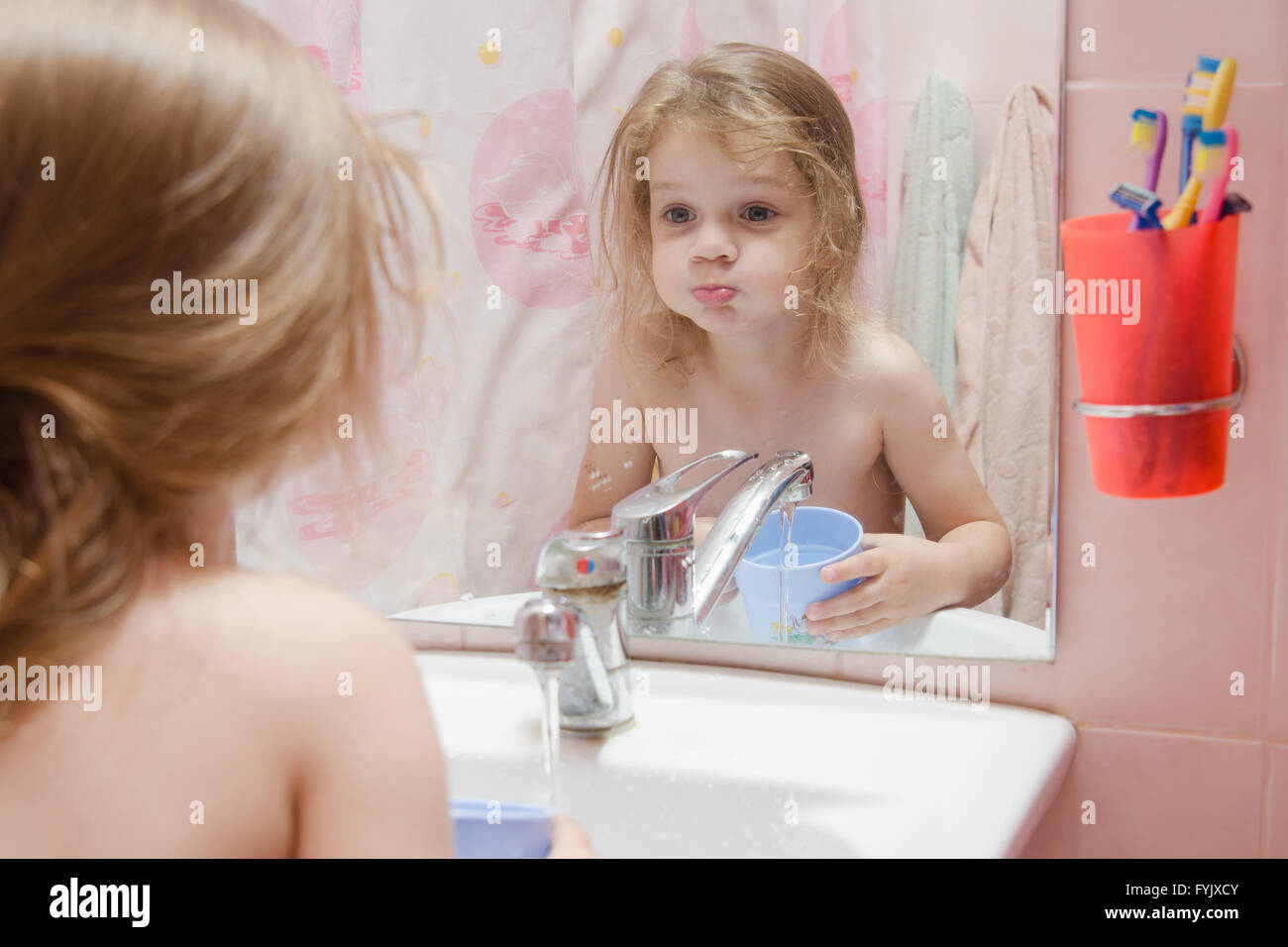 Three year girl to rinse your mouth after brushing teeth Stock Photo