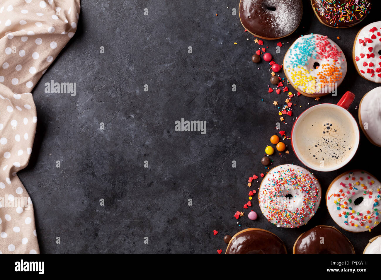 Colorful donuts and coffee on stone table. Top view with copy space ...