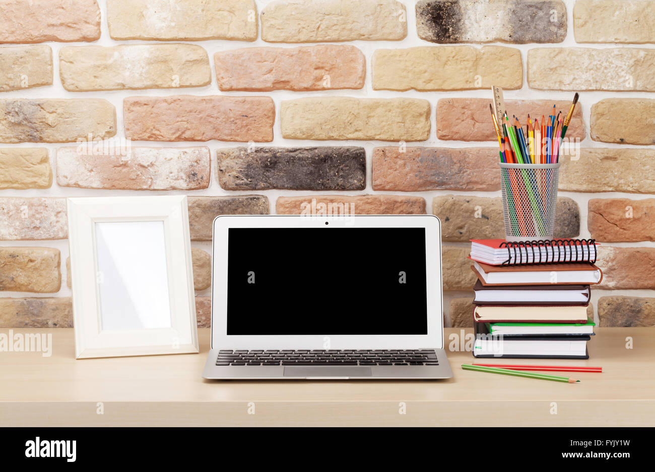 Office Desk Workplace With Laptop And Photo Frame In Front Of