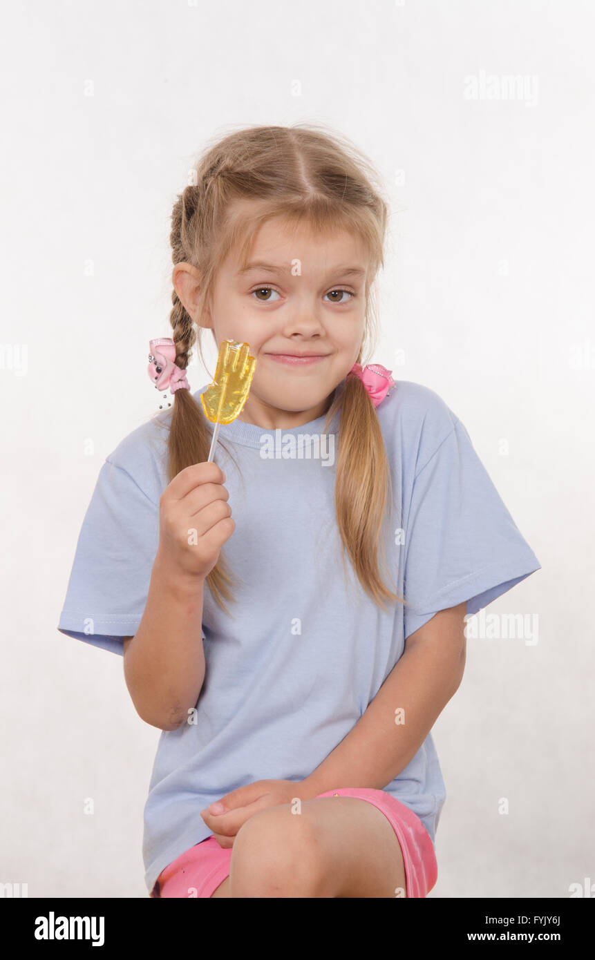 Portrait of five year girl with lollipop in her hand Stock Photo