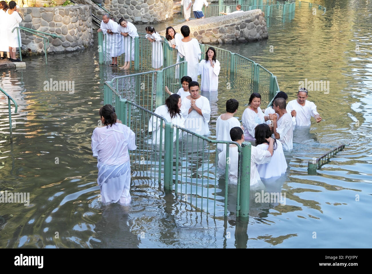 The ritual baptism of Christian pilgrims in the Jordan River Stock Photo