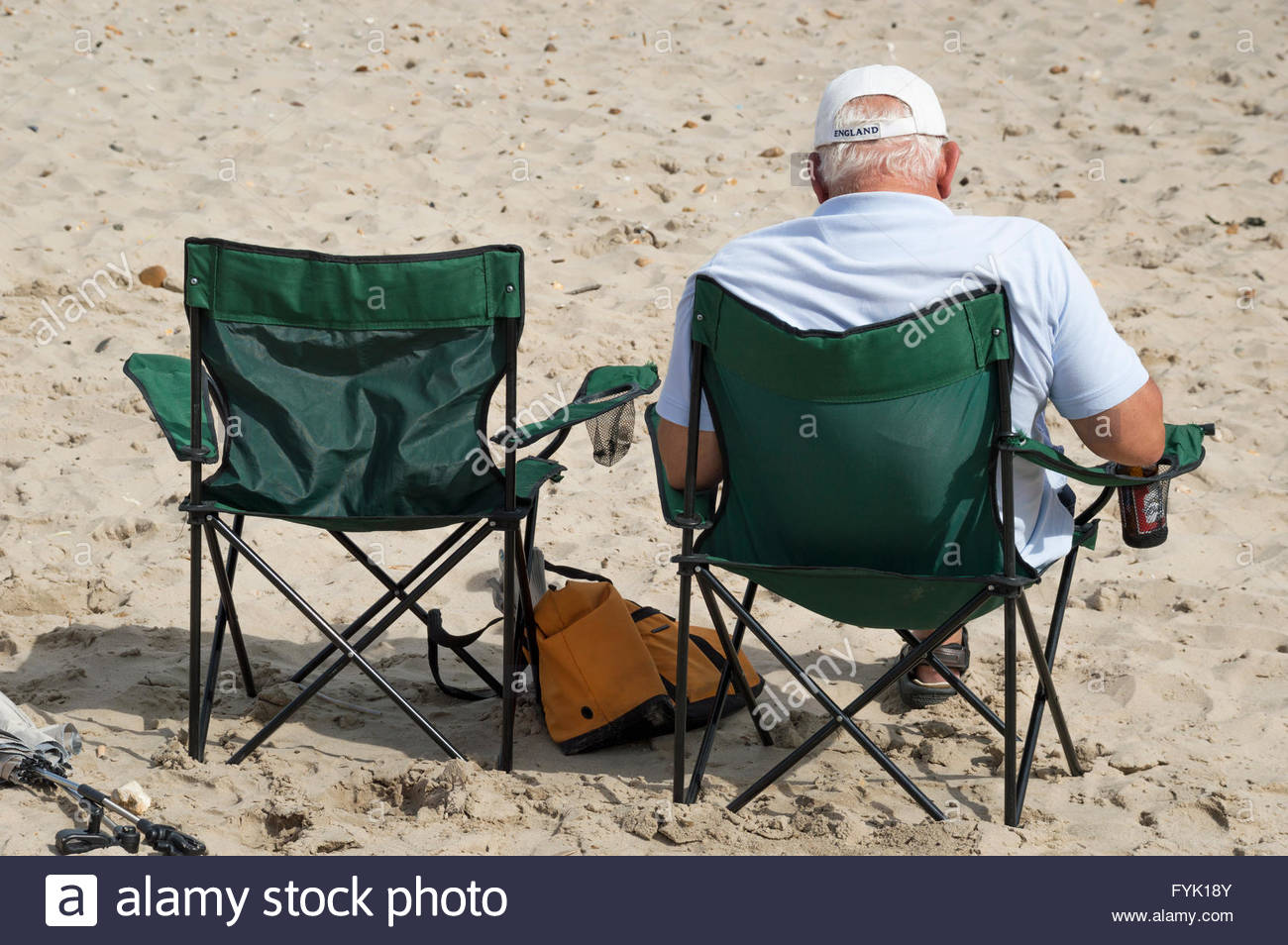 Older Man Sitting On The Beach In A Camping Chair Mudeford Dorset Stock Photo Alamy
