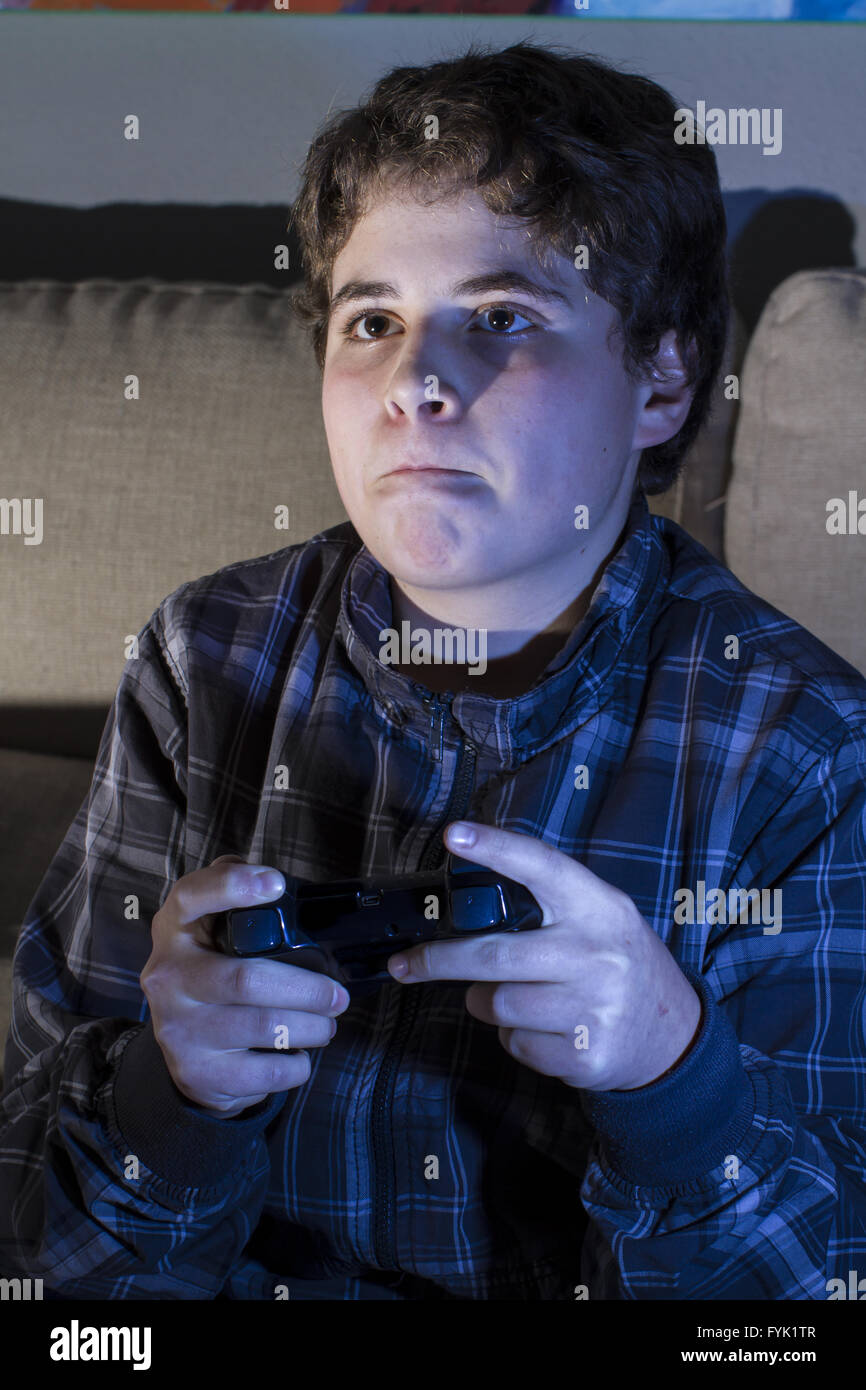 Leisure. boy with joystick playing computer game at home Stock Photo