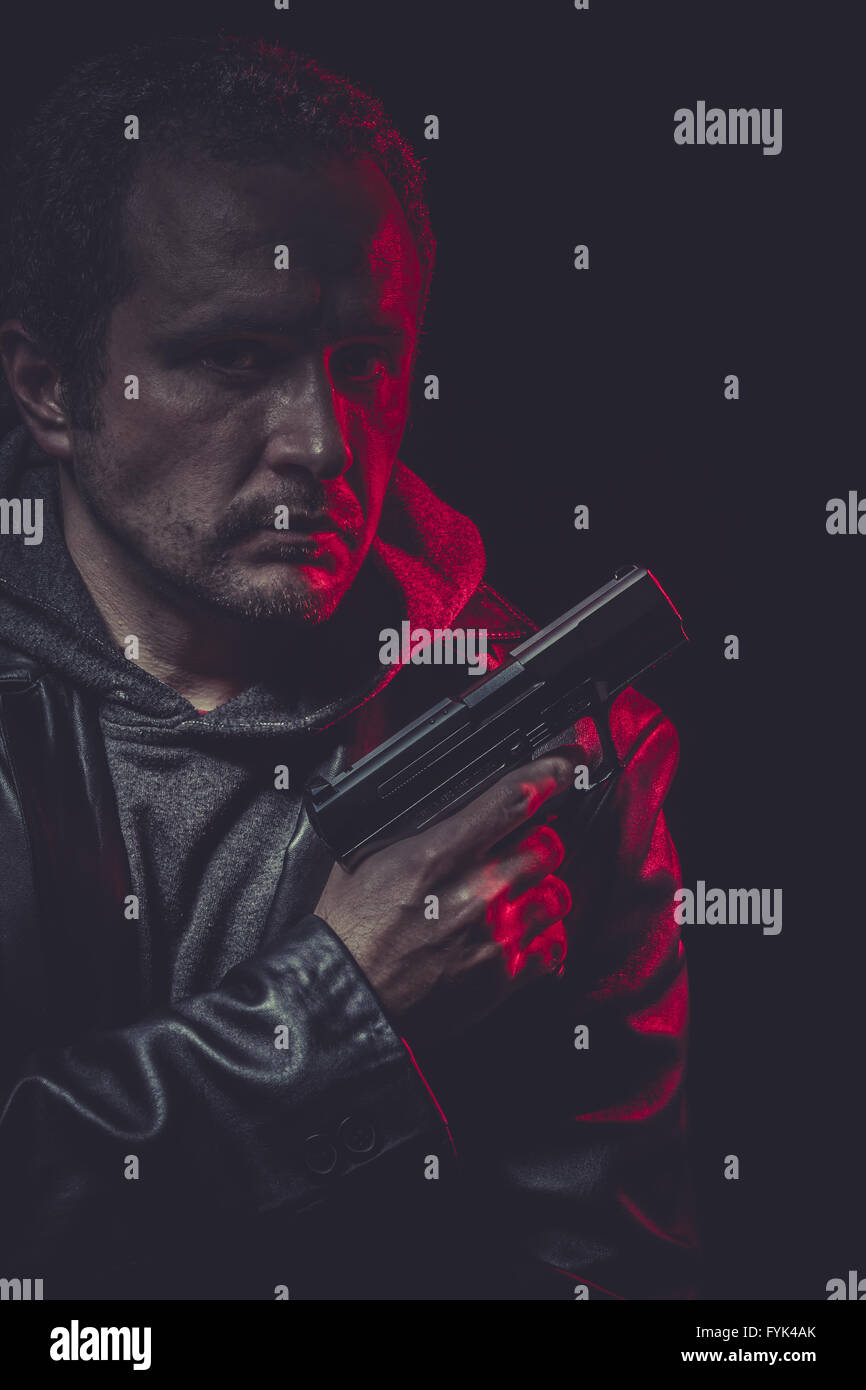 Murder, secret agent with gun and red light Stock Photo