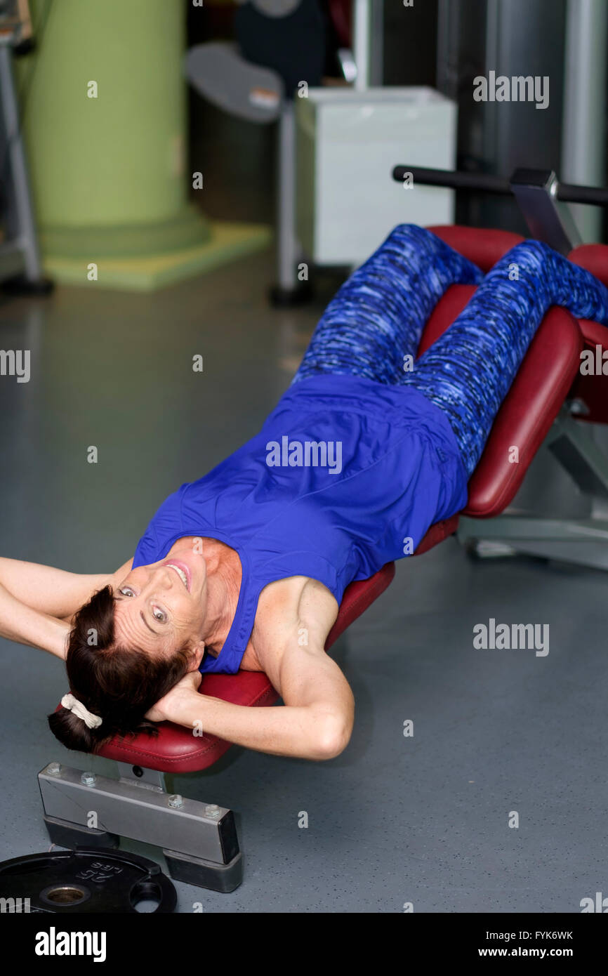 Retired woman working out at the gym Stock Photo