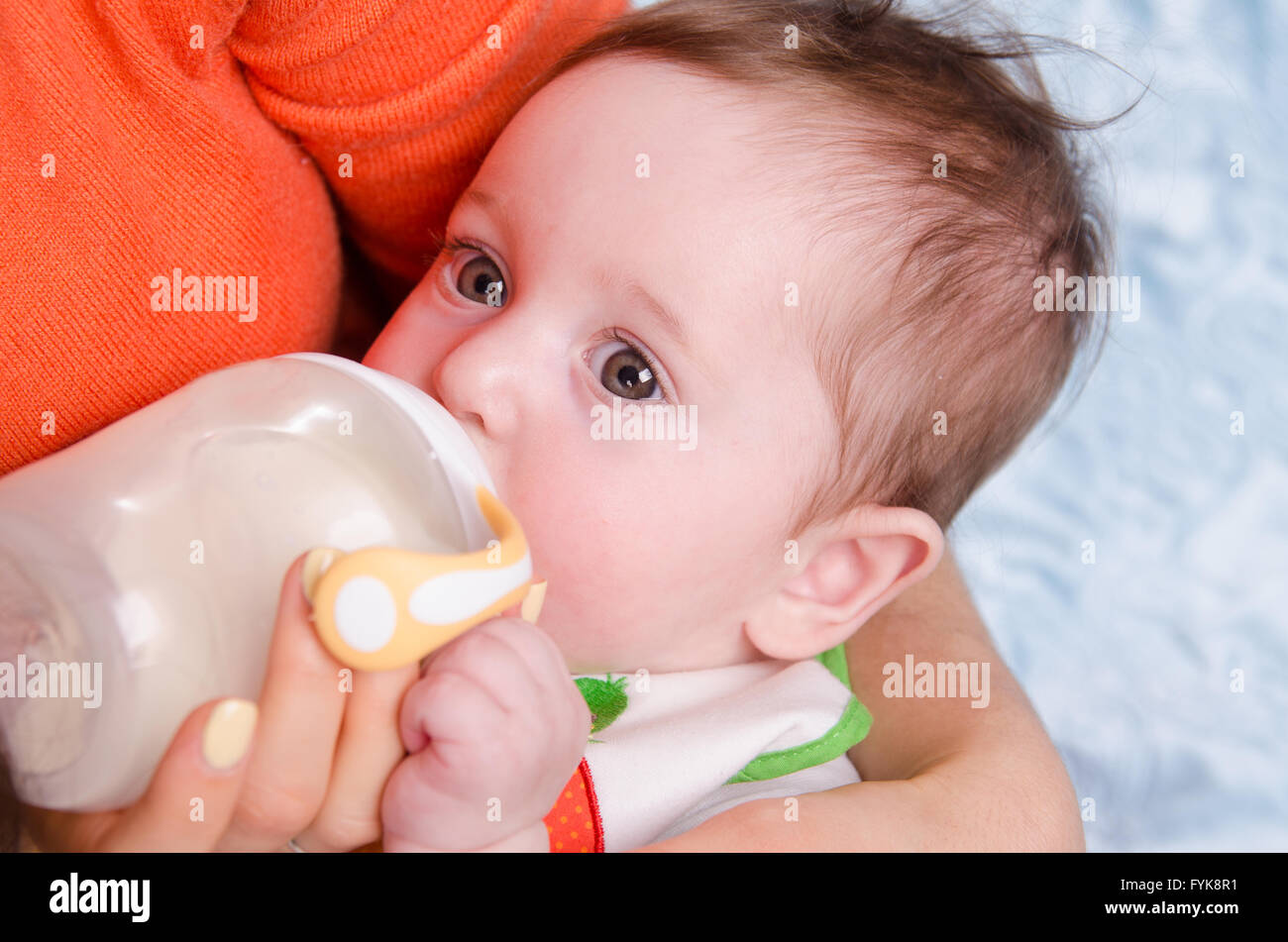 Six month old baby drinking milk from a bottle Stock Photo Alamy