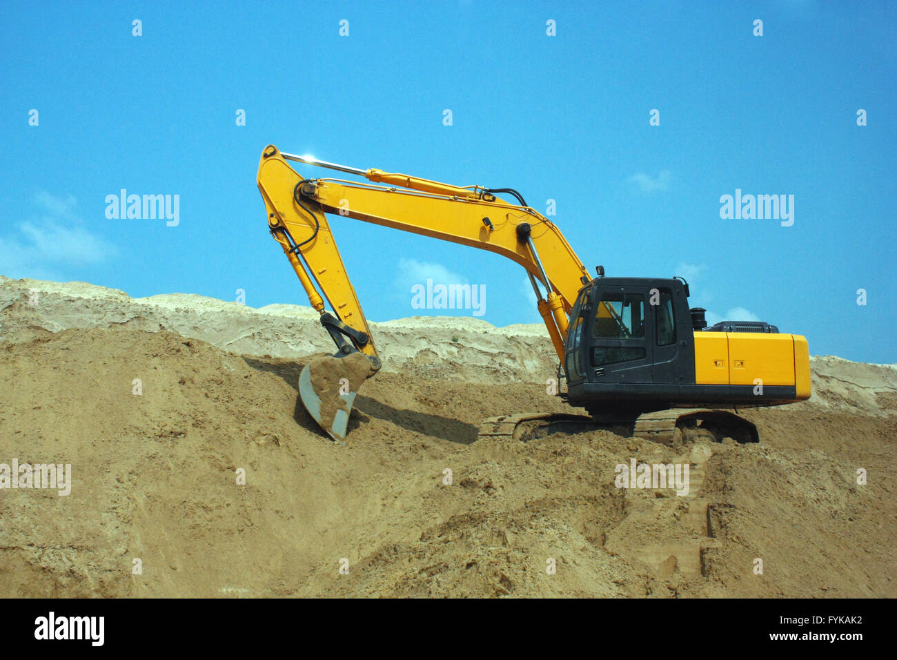 Yellow excavator, excavation work at a construction site Stock Photo ...