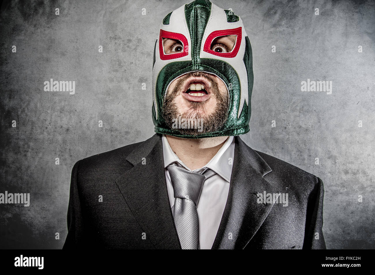 Trouble, businessman angry with Mexican wrestler mask Stock Photo