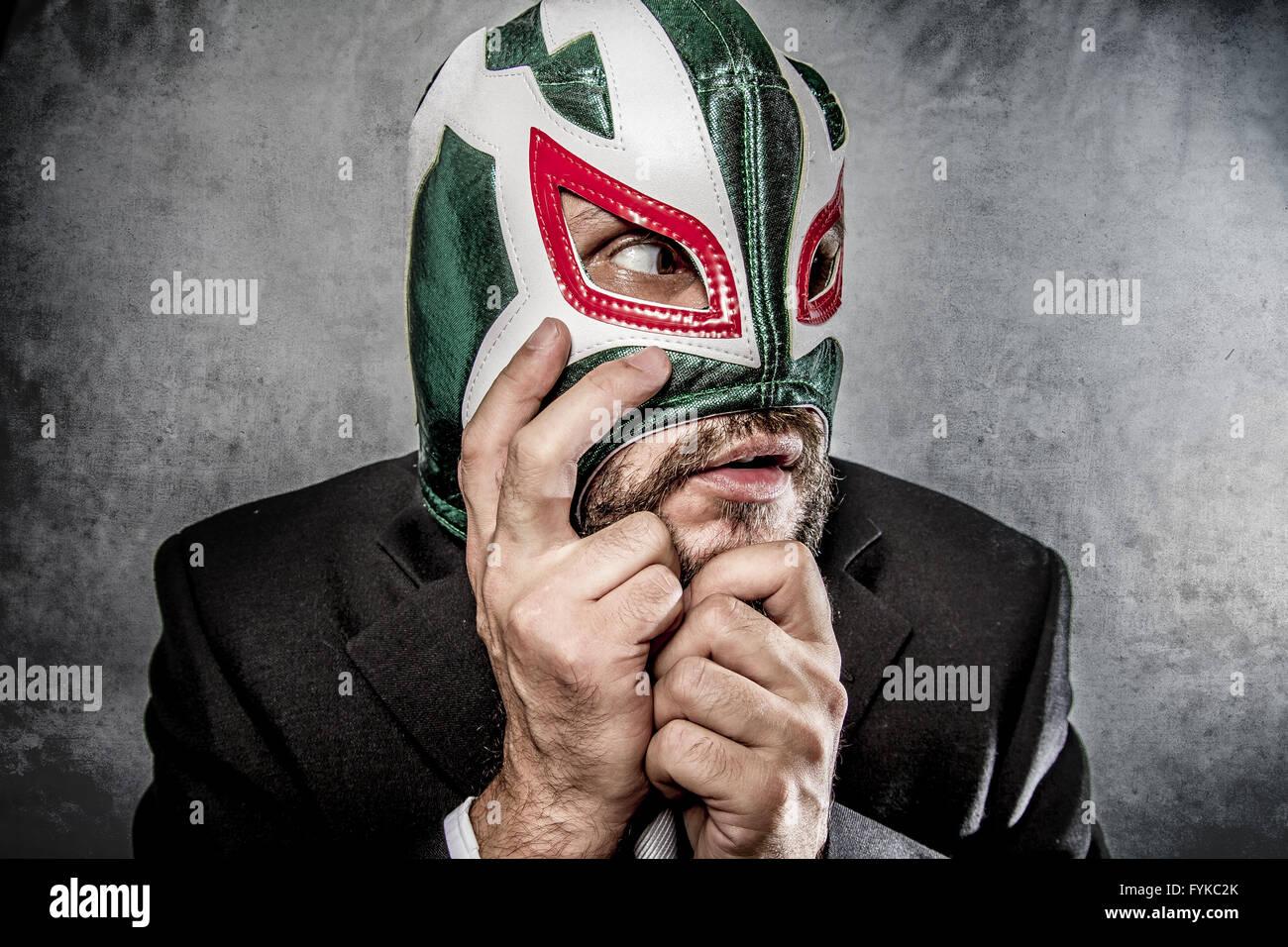Stress, businessman angry with Mexican wrestler mask Stock Photo