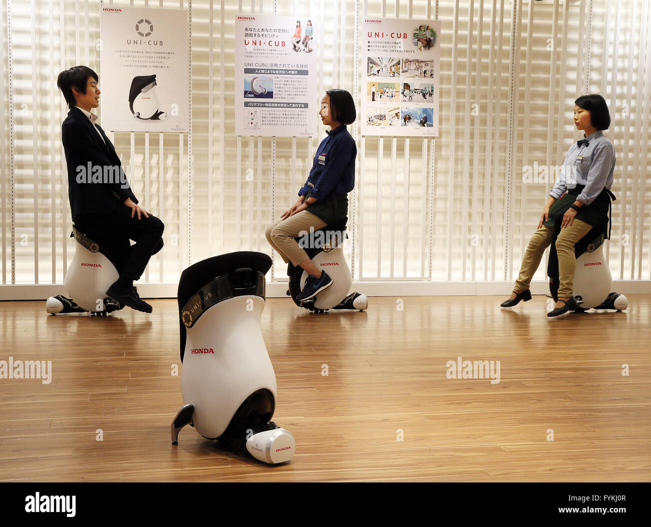 Tokyo, Japan. 27th Apr, 2016. Japan's Mitsukoshi department store employees demonstrate personal mobility devices 'Uni-Cub beta', developed by Japanese auto giant Honda Motor at the Hajimarino Cafe of the main store of Mitsukoshi in Tokyo on Wednesday, April 27, 2016. The Mitsukoshi and Honda started customer services using the saddle style mobility, such as test drive inside the department store. Credit:  Yoshio Tsunoda/AFLO/Alamy Live News Stock Photo