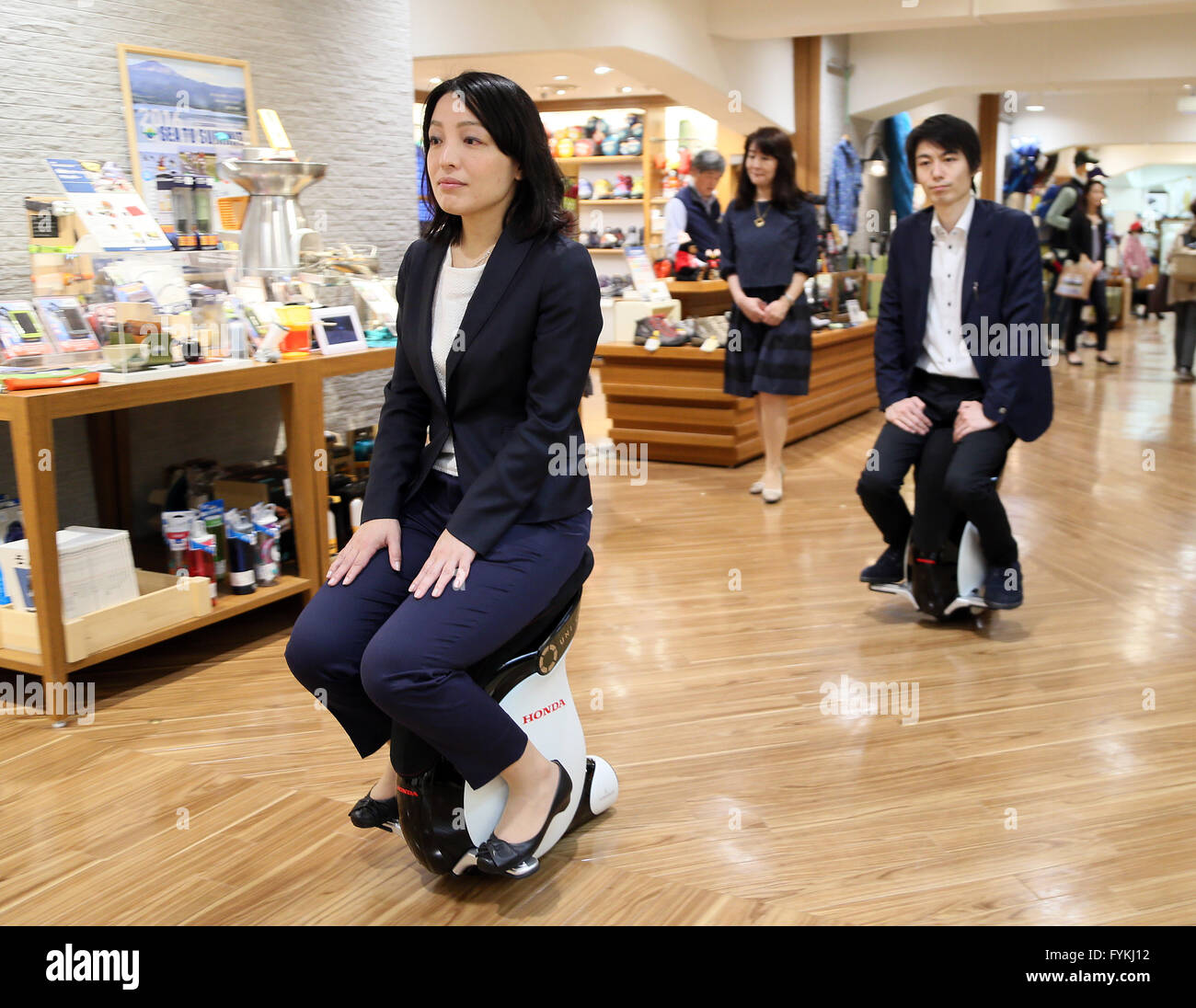 Tokyo, Japan. 27th Apr, 2016. Japan's Mitsukoshi department store employees demonstrate personal mobility devices 'Uni-Cub beta', developed by Japanese auto giant Honda Motor at the Hajimarino Cafe of the main store of Mitsukoshi in Tokyo on Wednesday, April 27, 2016. The Mitsukoshi and Honda started customer services using the saddle style mobility, such as test drive inside the department store. Credit:  Yoshio Tsunoda/AFLO/Alamy Live News Stock Photo