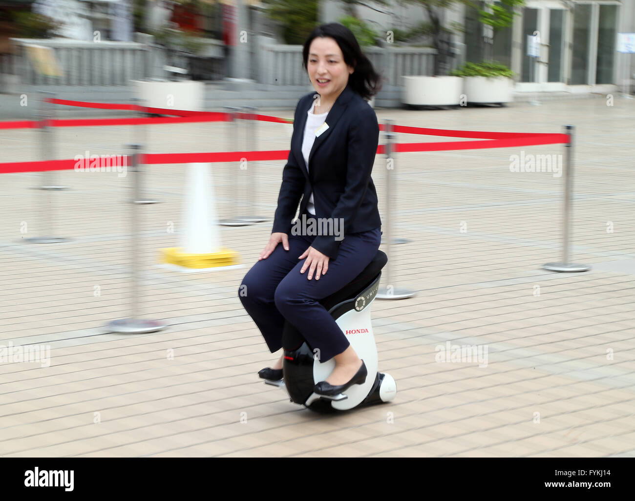 Tokyo, Japan. 27th Apr, 2016. Japan's Mitsukoshi department store employee demonstrates a personal mobility device 'Uni-Cub beta', developed by Japanese auto giant Honda Motor at the Hajimarino Cafe of the main store of Mitsukoshi in Tokyo on Wednesday, April 27, 2016. The Mitsukoshi and Honda started customer services using the saddle style mobility, such as test drive inside the department store. Credit:  Yoshio Tsunoda/AFLO/Alamy Live News Stock Photo