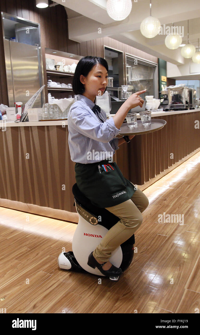 Tokyo, Japan. 27th Apr, 2016. Japan's Mitsukoshi department store employee demonstrates a personal mobility device 'Uni-Cub beta', developed by Japanese auto giant Honda Motor at the Hajimarino Cafe of the main store of Mitsukoshi in Tokyo on Wednesday, April 27, 2016. The Mitsukoshi and Honda started customer services using the saddle style mobility, such as test drive inside the department store. Credit:  Yoshio Tsunoda/AFLO/Alamy Live News Stock Photo