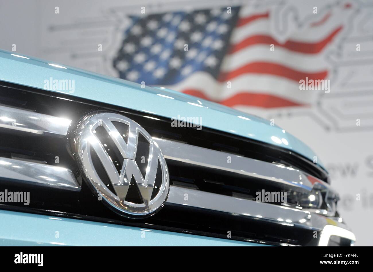 A car from Volkswagen stands in front of a flag of the United States of America, Germany, city of Hannover, 25. April 2016. Photo: Frank May Stock Photo