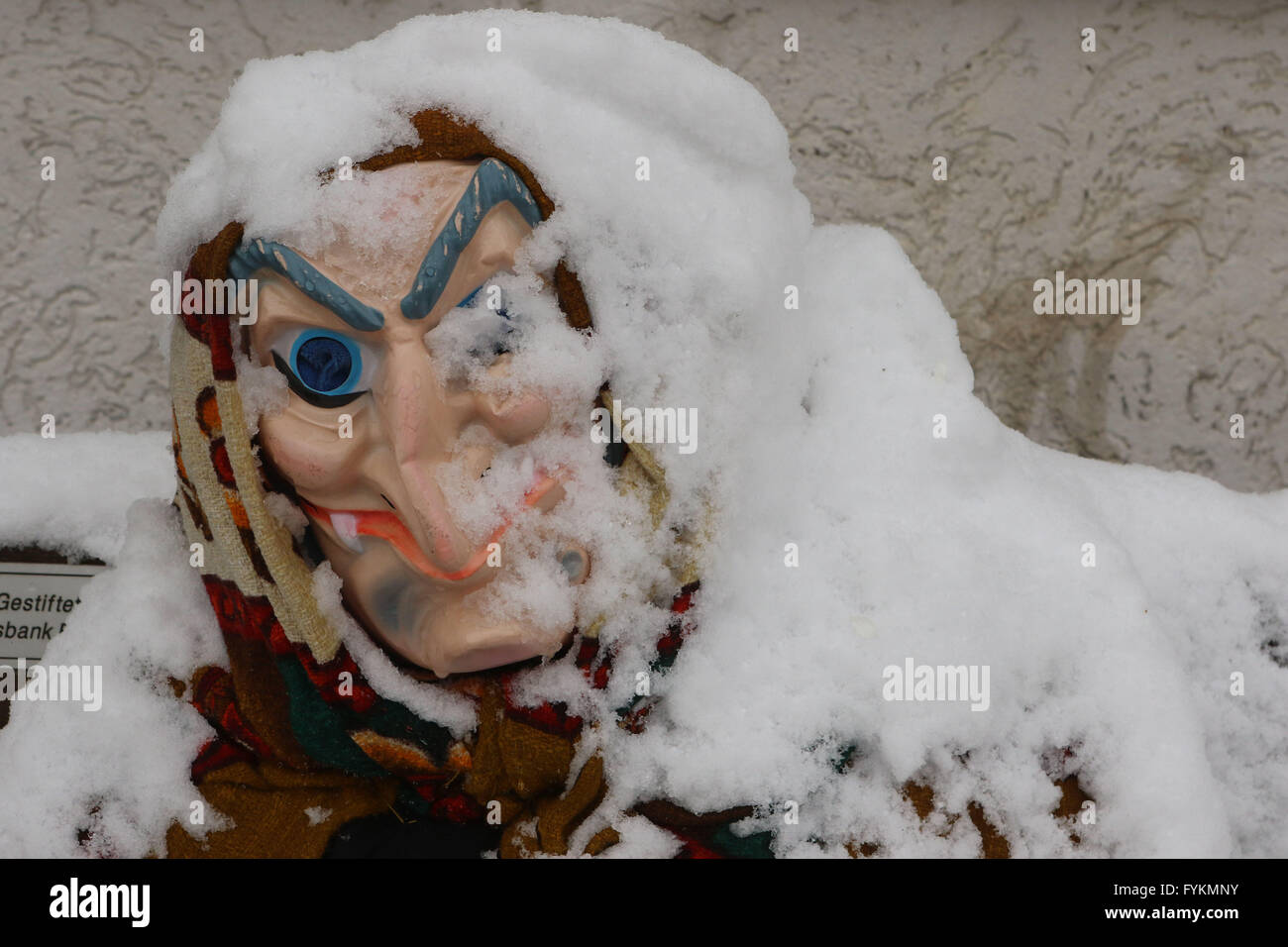 A witch figure sits on a snow-covered bench in Hohegeiss, Germany, 27 April 2016. Photo: MATTHIAS BEIN/dpa/lah/lni  - NO WIRE SERVICE - Stock Photo