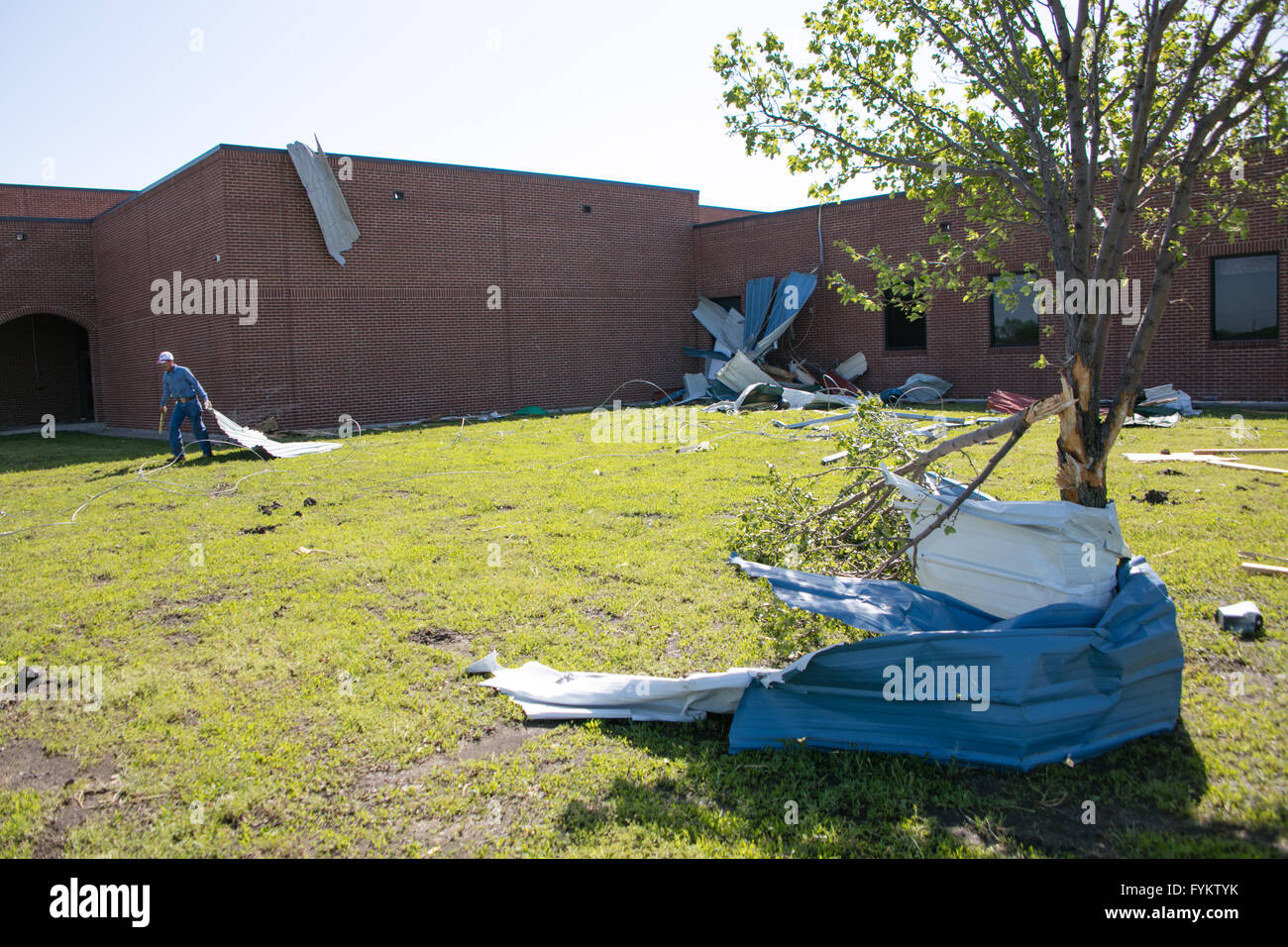 Grayson County, Texas, USA. 27th Apr, 2016. A man cleans the lawn of Howe High School, at Grayson County, Texas, United States. One woman was killed and five others were injured after powerful storms and tornadoes lashed out at the southern U.S. states of Texas and Oklahoma starting from Tuesday night, local TV station ABC13 reported on Wednesday. Credit:  Tian Dan/Xinhua/Alamy Live News Stock Photo