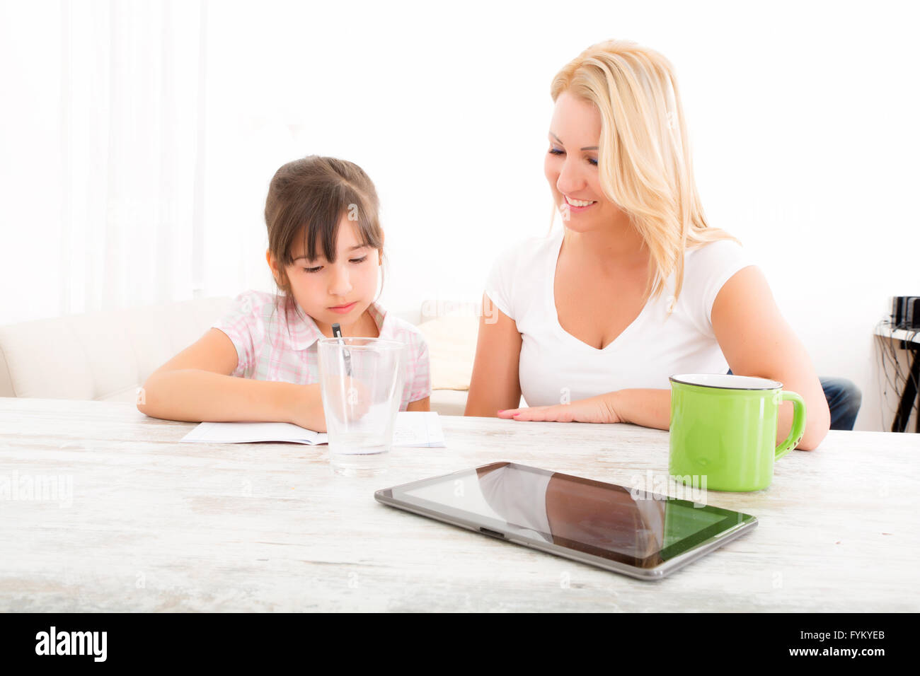Mother helping her daughter with the homework Stock Photo - Alamy