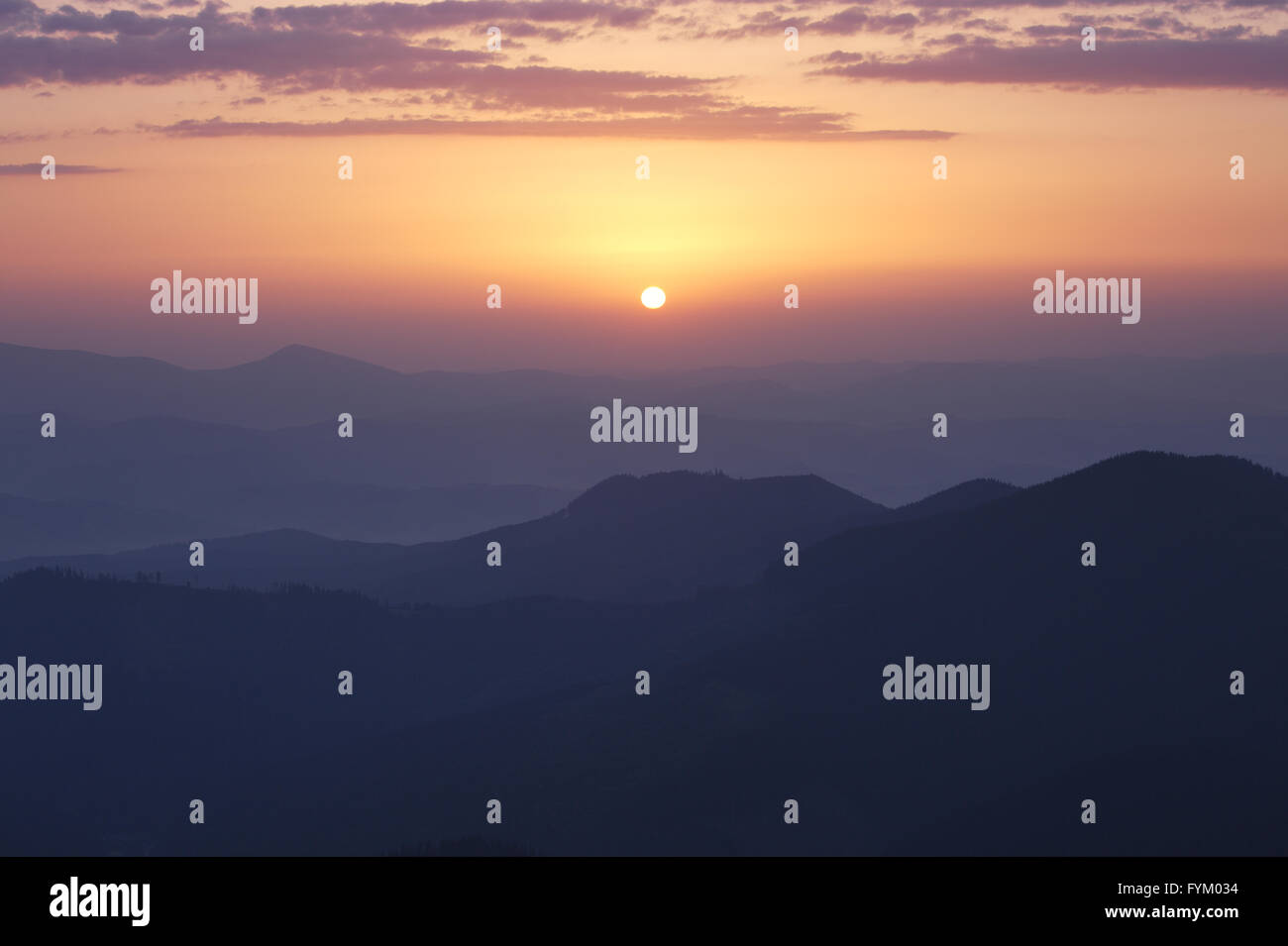 Rising sun under Carpathian mountains Stock Photo