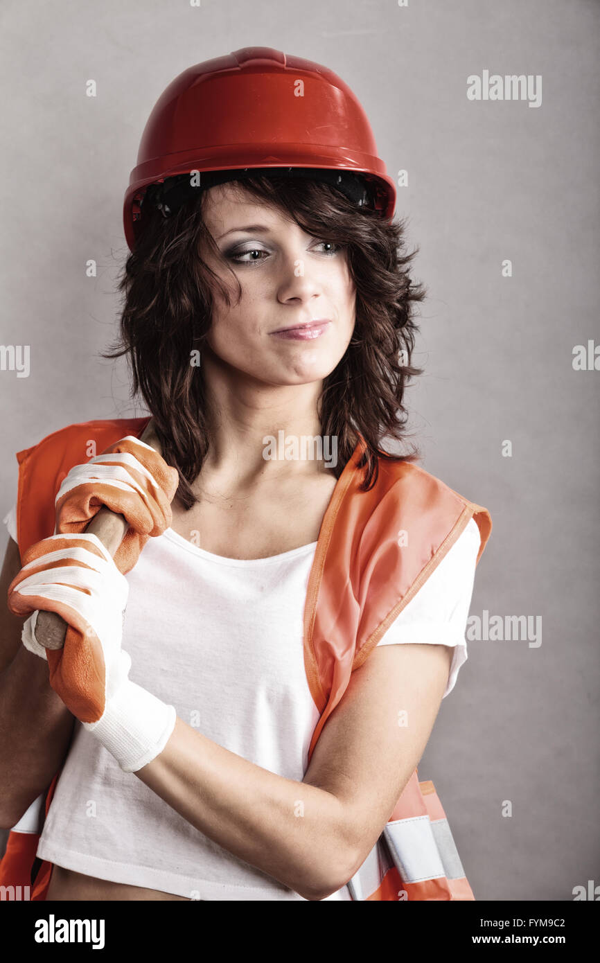 Sex equality and feminism Sexy girl in safety helmet orange vest  