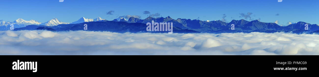 Aerial view on Alps mountains upon clouds, seen from upon Fribourg, Switzerland Stock Photo