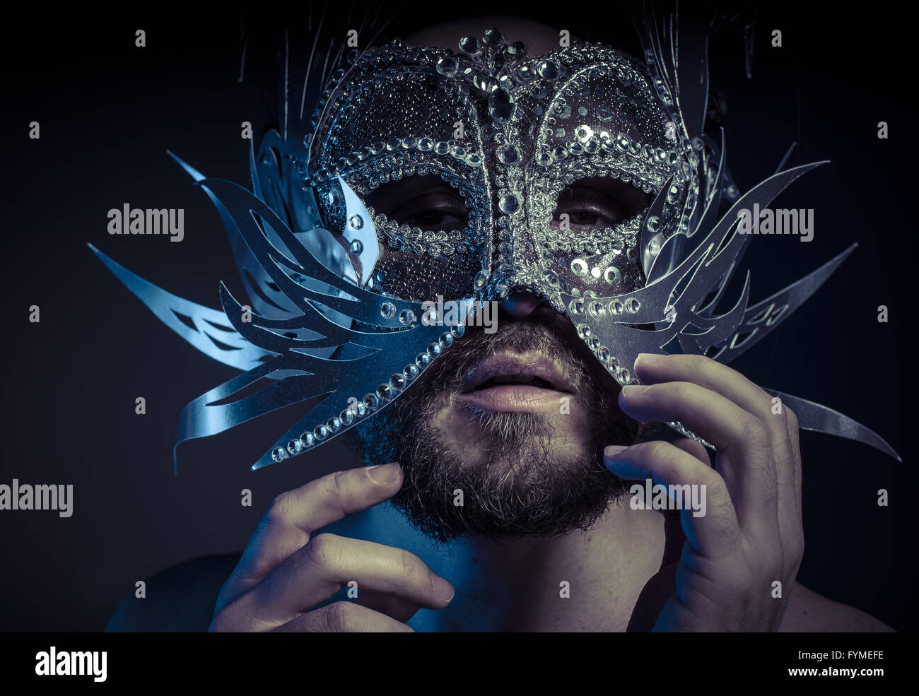 Ego, bearded man with silver mask style. Mystery and