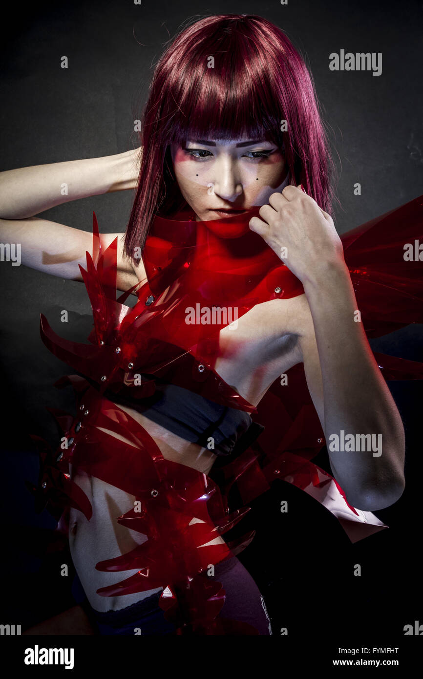 Future, robot with red armor, beautiful young Japanese woman in a suit methacrylate Stock Photo