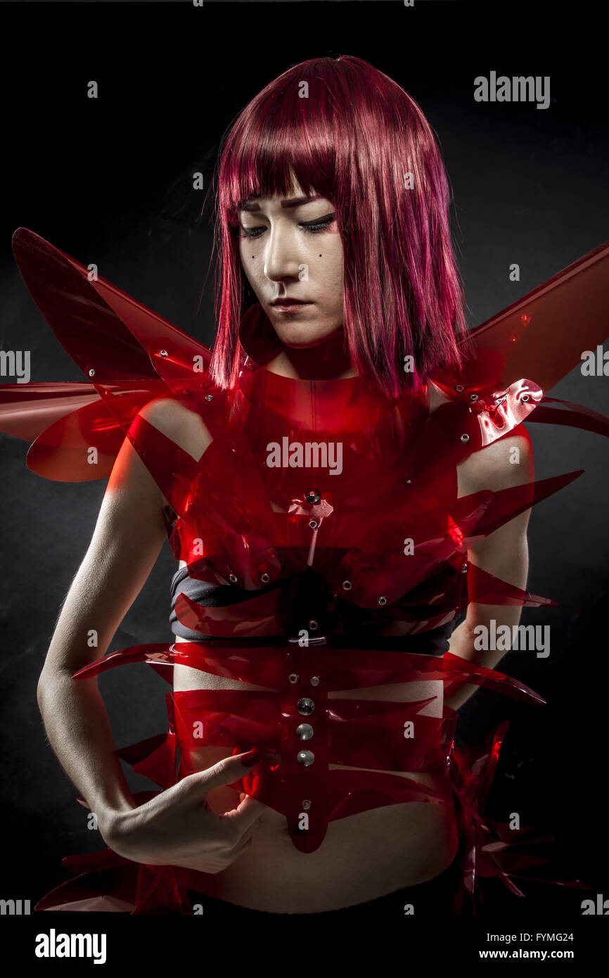 robot with red armor, beautiful young Japanese woman in a suit methacrylate Stock Photo