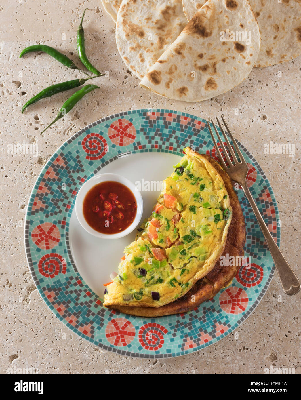 Masala omelette. Spicy Indian omelet with chilli ketchup and chapatis