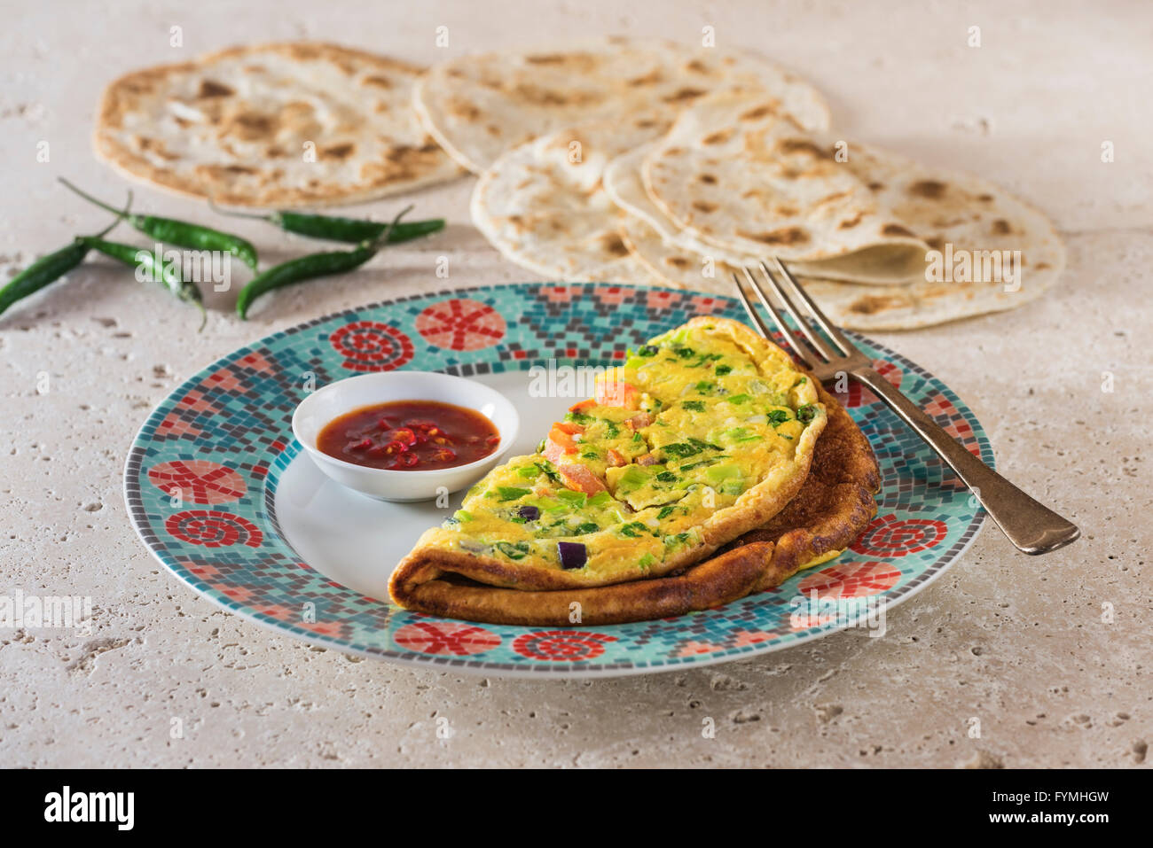 Masala omelette. Spicy Indian omelet with chilli ketchup and chapatis