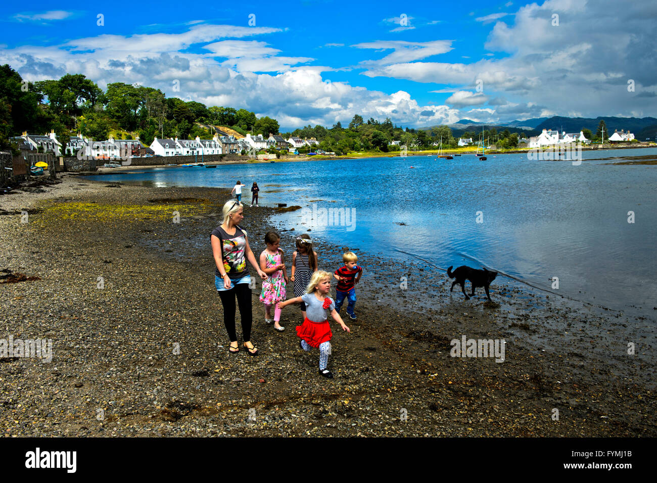 Family strolling along the shores of Loch Carron in Plockton, Ross and Cromarty, Scottish Highlands, Scotland, Great Britain Stock Photo
