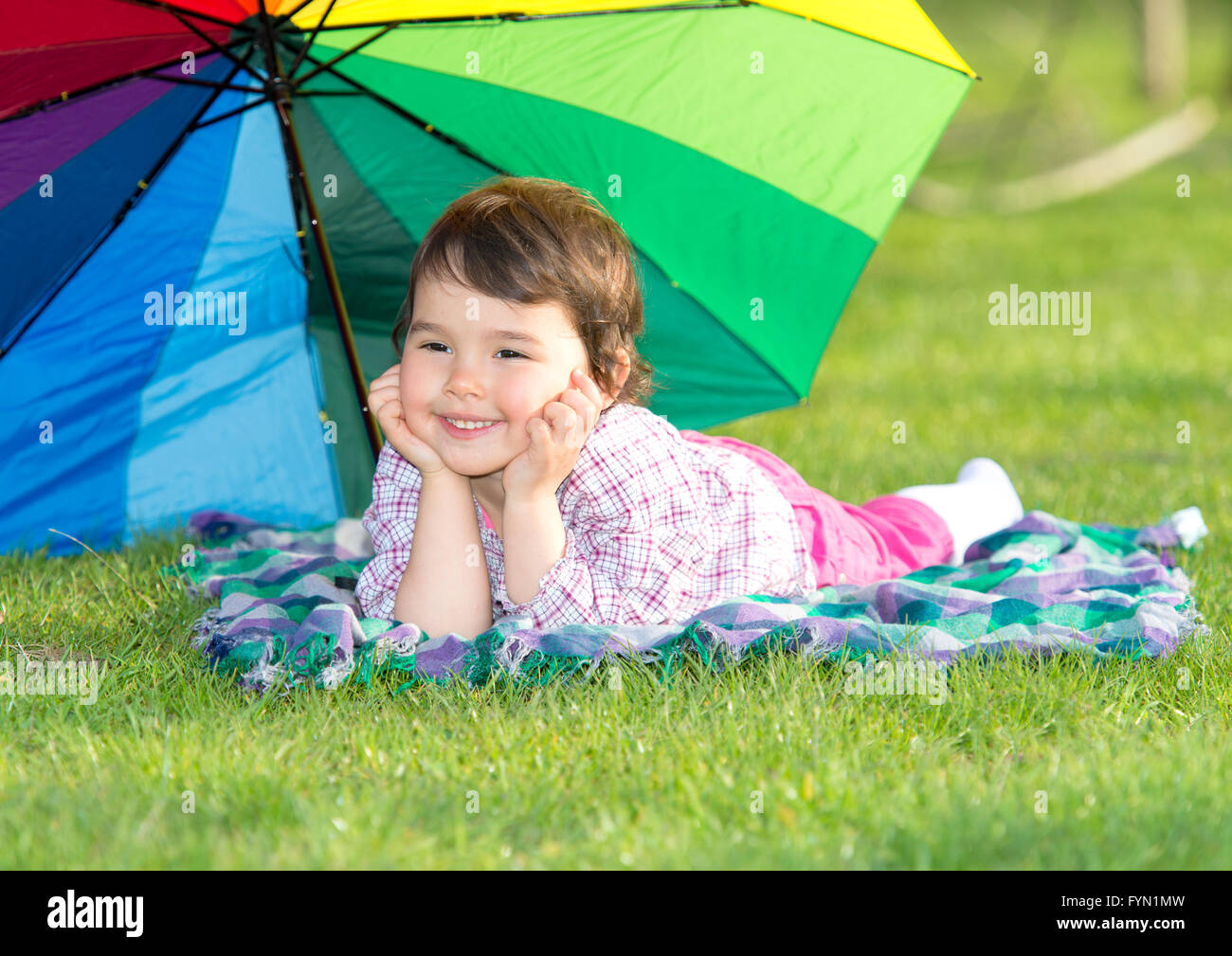 little happy girl with a rainbow umbrella in park Stock Photo - Alamy