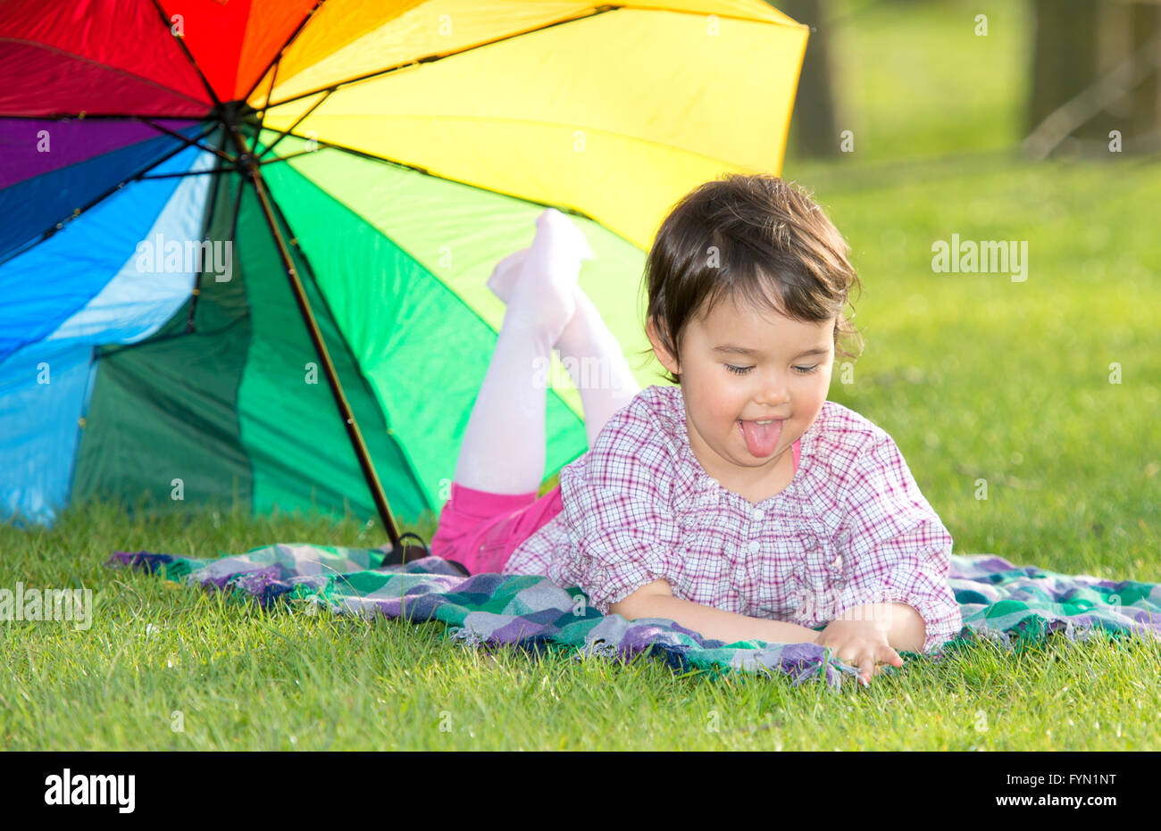 little happy girl with a rainbow umbrella in park Stock Photo - Alamy