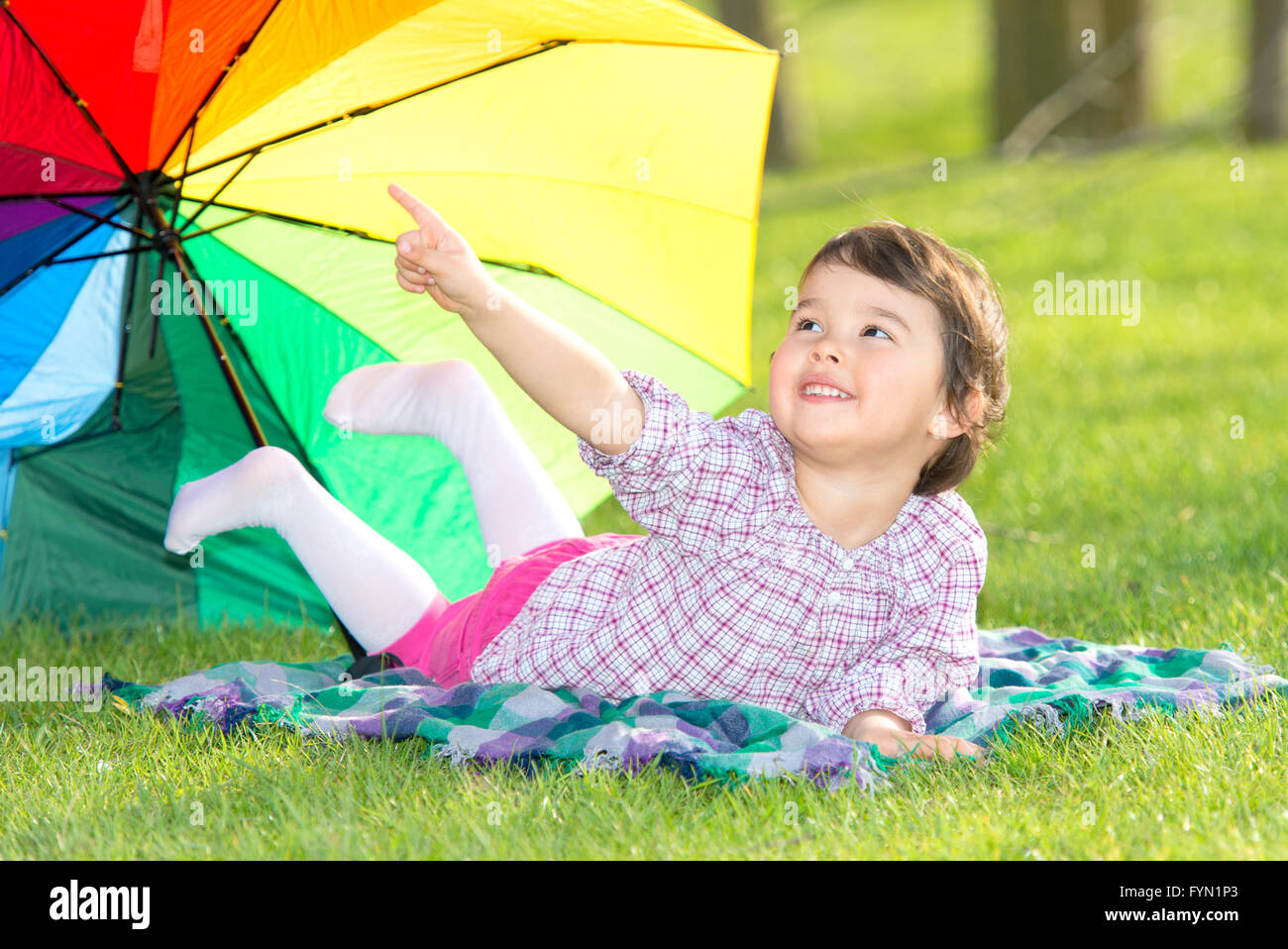 little happy girl with a rainbow umbrella in park Stock Photo - Alamy