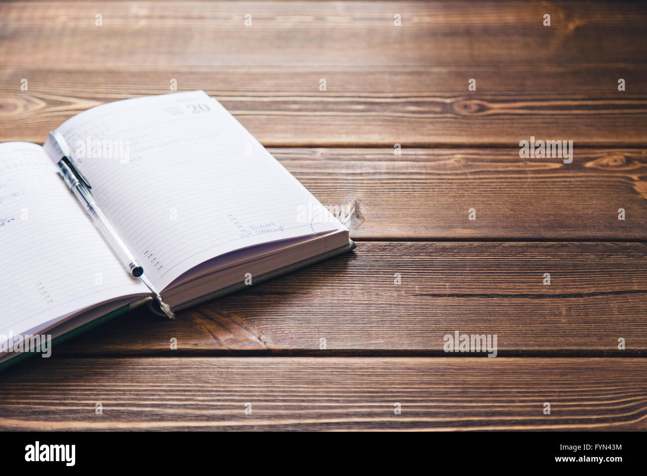 Diary book on the brown wooden desk Stock Photo