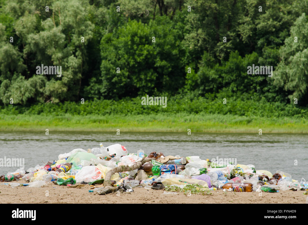 pile of garbage in the river and forest Stock Photo