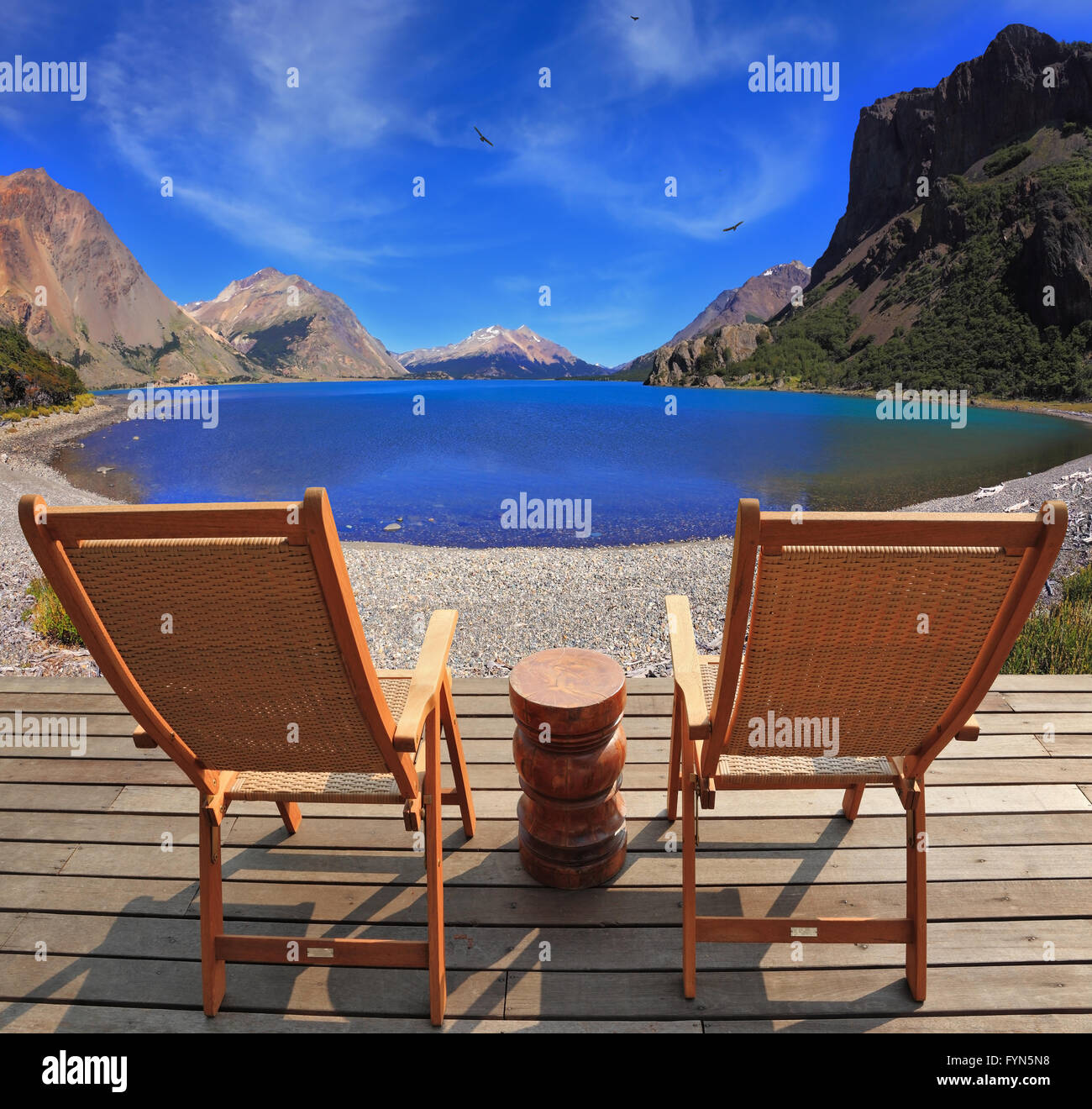 Two folding wooden chairs and the mountain lake Stock Photo - Alamy