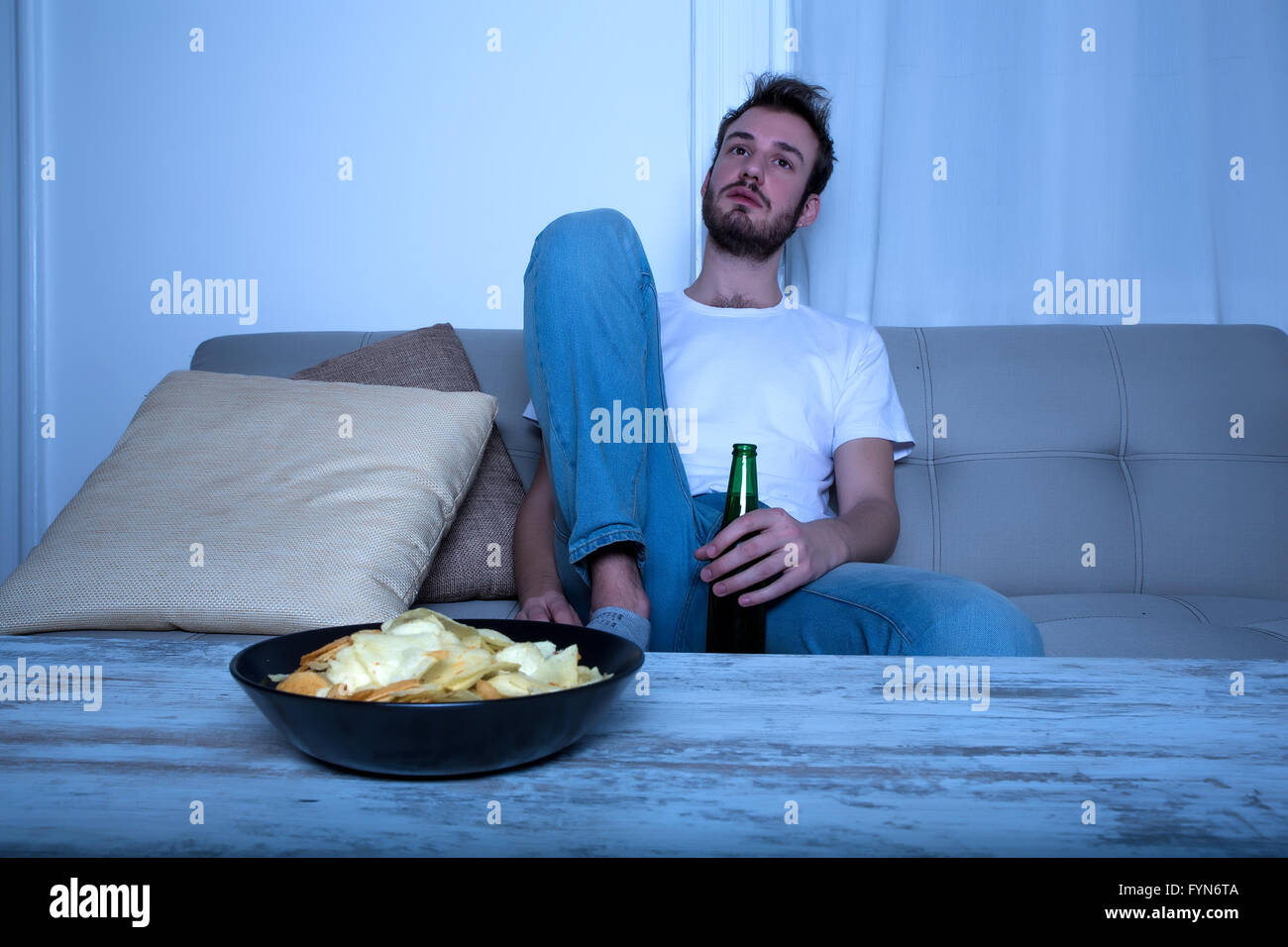Watching tv alone at nighttime hi-res stock photography and images - Alamy