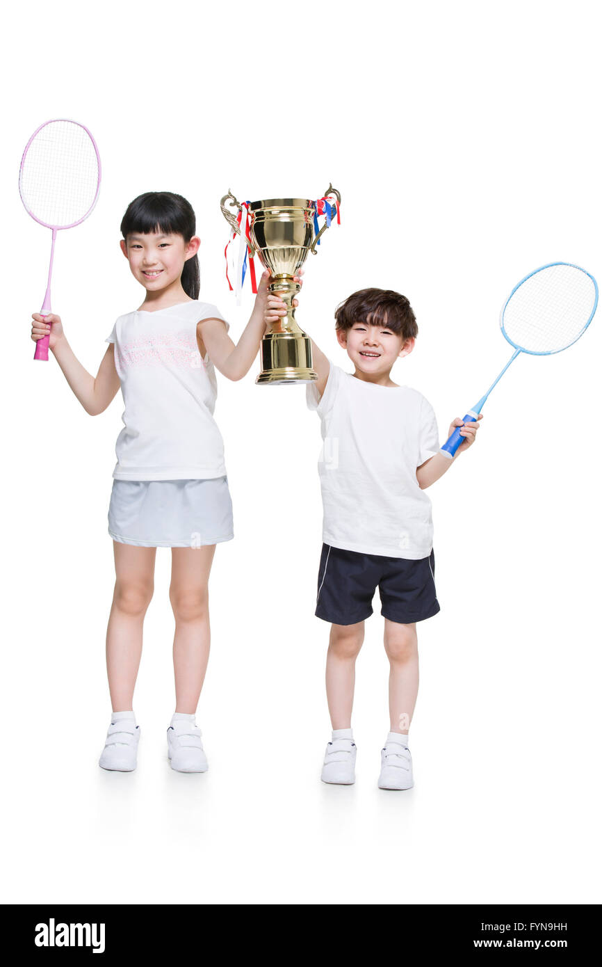 Cute children holding badminton rackets and trophy Stock Photo