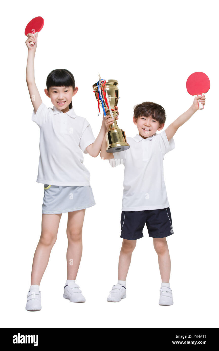 Cute children holding table tennis rackets and trophy Stock Photo