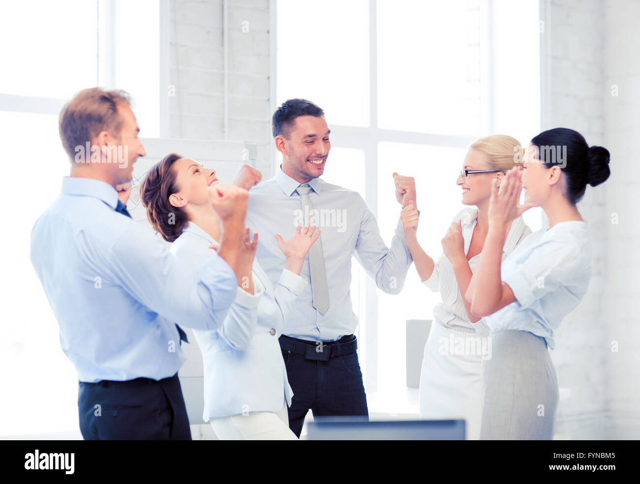 business team celebrating victory in office Stock Photo - Alamy