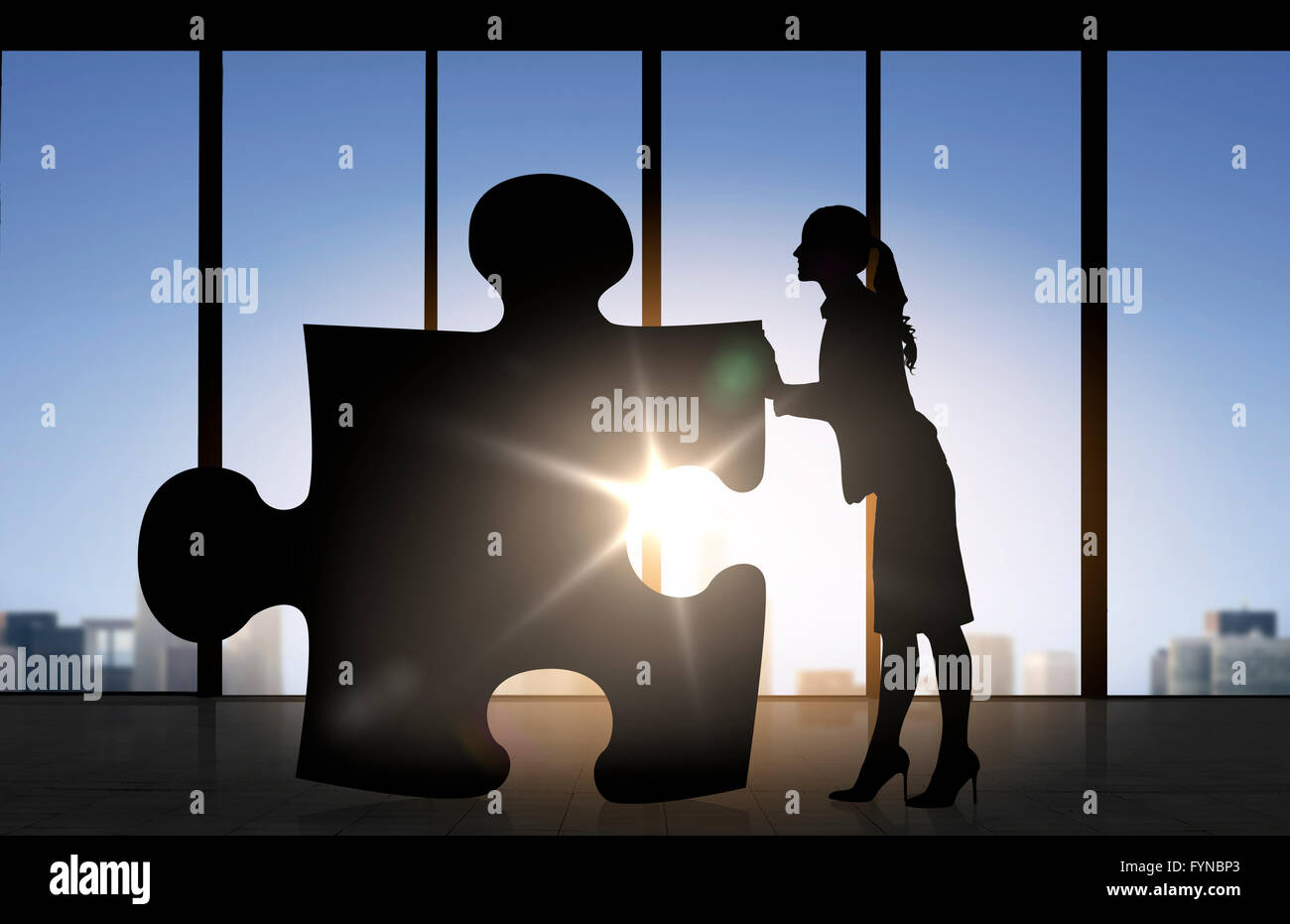 silhouette of woman mowing puzzle over office Stock Photo