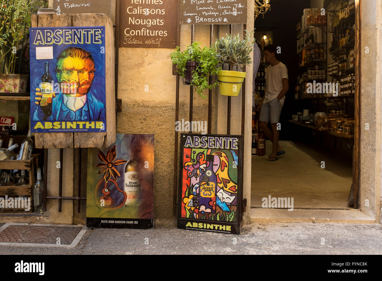 Village shop with a poster of Van Gogh holding a bottle of Absinth, Lourmarin, Vaucluse, Provence-Alpes-Côte d'Azur, France Stock Photo