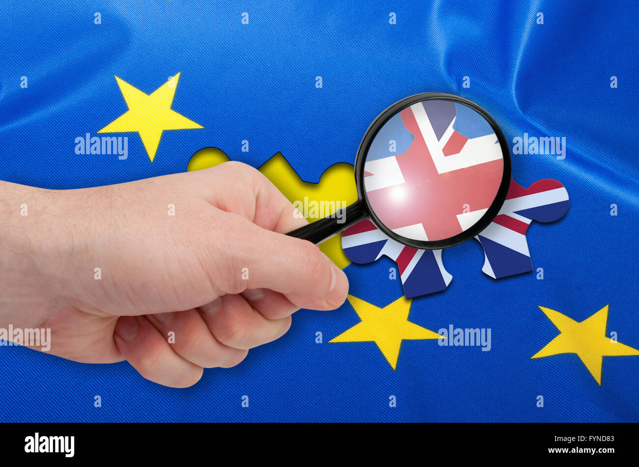 Brexit - Hand With Magnifying glass Silky Flag Over European Union EU Flag Drapery With Puzzle Piece With Great Britain Stock Photo