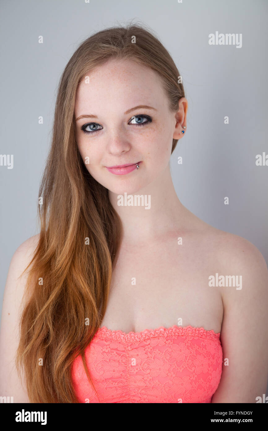 A teenage girl with long ginger hair down one side of her face