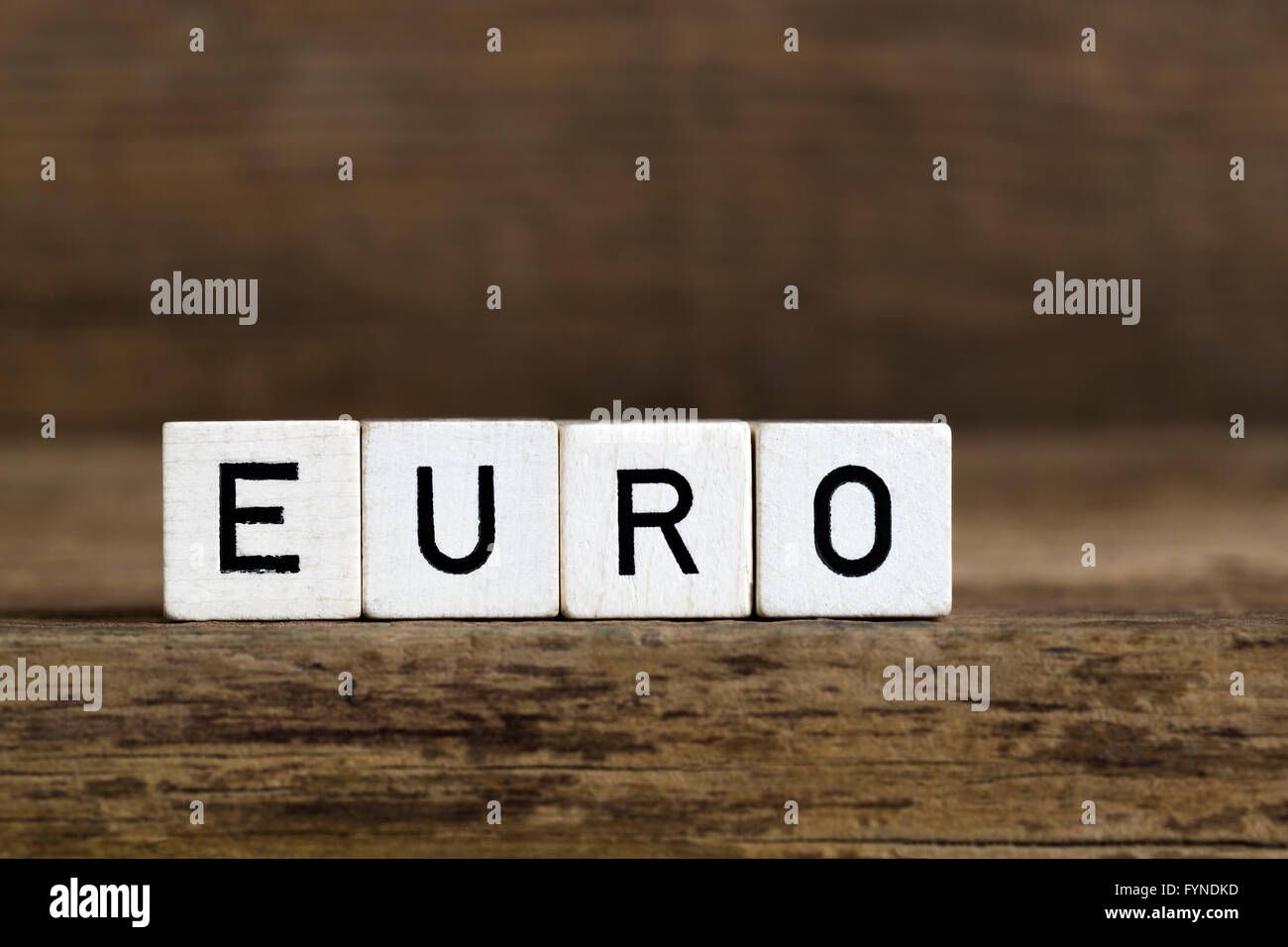 The word euro written in cubes on wooden background Stock Photo